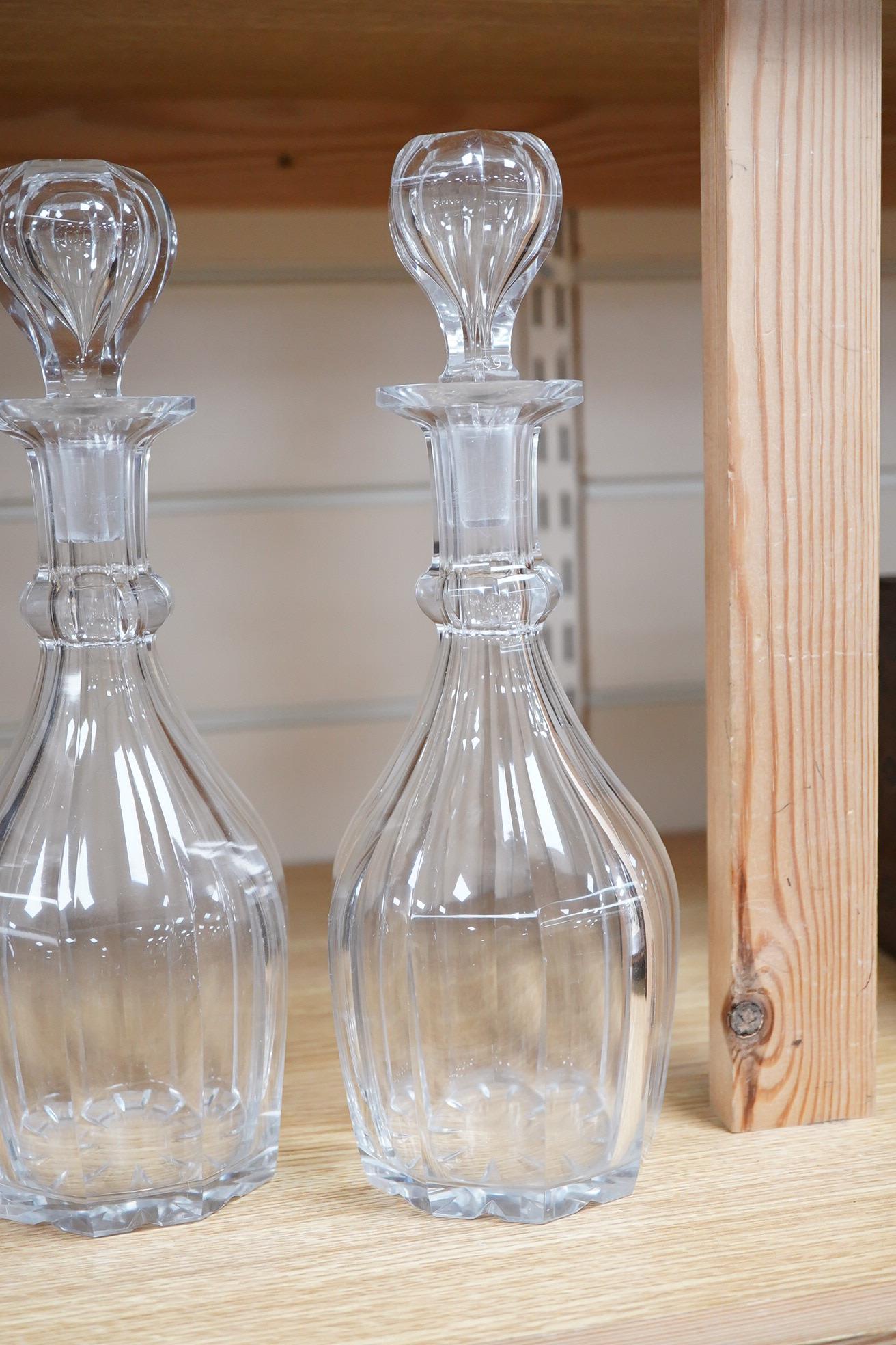 A pair small cut glass decanters and stoppers - 27cm high and a larger similar single decanter and stopper